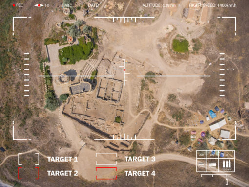 This image is a high altitude aerial view of a military training exercise, looking down on the training area. The training area is a large open space with buildings, roads, and trees. The image is overlaid with white text and lines, indicating target locations and other information. The image also has a white border with additional information, such as ‘REC’, ‘TIME’, ‘DATE’, ‘ALTITUDE’, and ‘FLIGHT SPEED’.