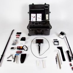 A collection of United States military and Department of Defense equipment and supplies, including a black hard case, a camera, a metal detector, and various tools and accessories. The items are arranged on a white background. The largest item is a black hard case with a handle and two latches. The case is open and there are two white sheets of paper with text and images on them inside. To the left of the case, there is a long metal detector with a black handle. To the right of the case, there is a black camera with a red strap. There are various tools and accessories scattered around the case, including a flashlight, a screwdriver, a pair of pliers, and several cables and cords.