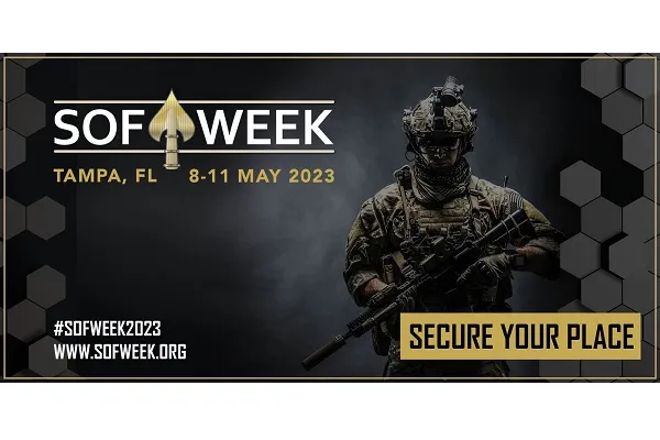 This is a digital image of a promotional poster for SOF Week 2023 in Tampa, FL. The background is black with a hexagonal pattern. The poster features white text that reads ‘SOF Week Tampa, FL 8-11 May 2023’, and ‘Secure Your Place’ is written in yellow font. The hashtags ‘#SOFWeek2023’ and the website ‘www.sofweek.org’ are also displayed in white font. The image also includes a depiction of a soldier in full gear, holding a rifle and wearing a helmet with a night vision device attached.