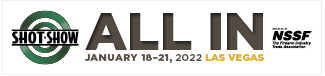 This image is a banner for the SHOT Show 2022 event. It has a white background with black and green text. The text reads ‘ALL IN’ in large black letters, and below it are the dates ‘January 18-21, 2022’ in smaller black letters. To the left of the text is the SHOT Show logo, a green circle with a white target and the text ‘SHOT Show’ in white letters. To the right of the text is the NSSF logo, a black square with the text ‘NSSF’ in white letters and ‘The Firearms Industry Trade Association’ in smaller white letters. The banner is promoting the SHOT Show.
