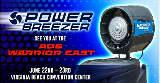 This image is an advertisement for Power Breezer, a portable cooling unit. The background is blue with a pattern of white dots. The main focus of the image is a black and blue portable cooling unit with a large fan on top. The text on the image reads ‘See you at the ADS Warrior East’ and ‘June 22nd - 23rd Virginia Beach Convention Center’. The Power Breezer logo is visible in the top left corner.